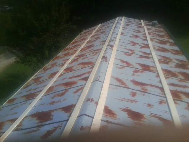 Rusted metal roof panels with new wood purlins before replacement — Storm Damage Roof Repair in Lindsay by Roofing Brothers